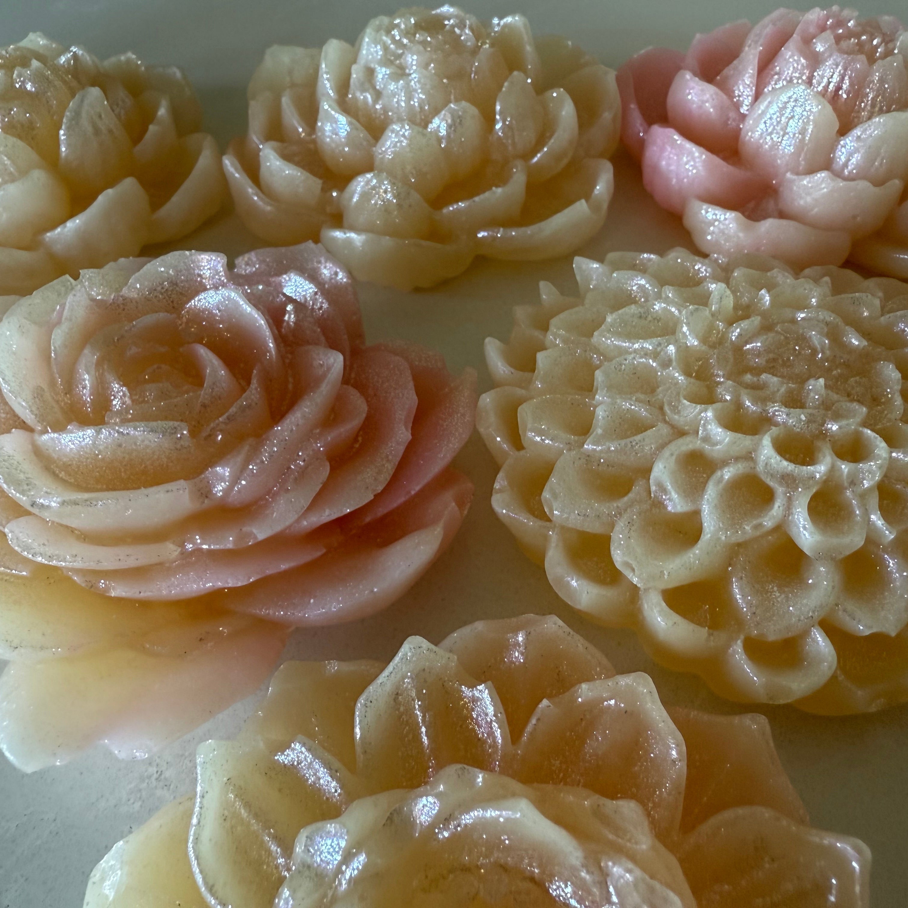 Decorative flower-shaped candies in various colors on a white background